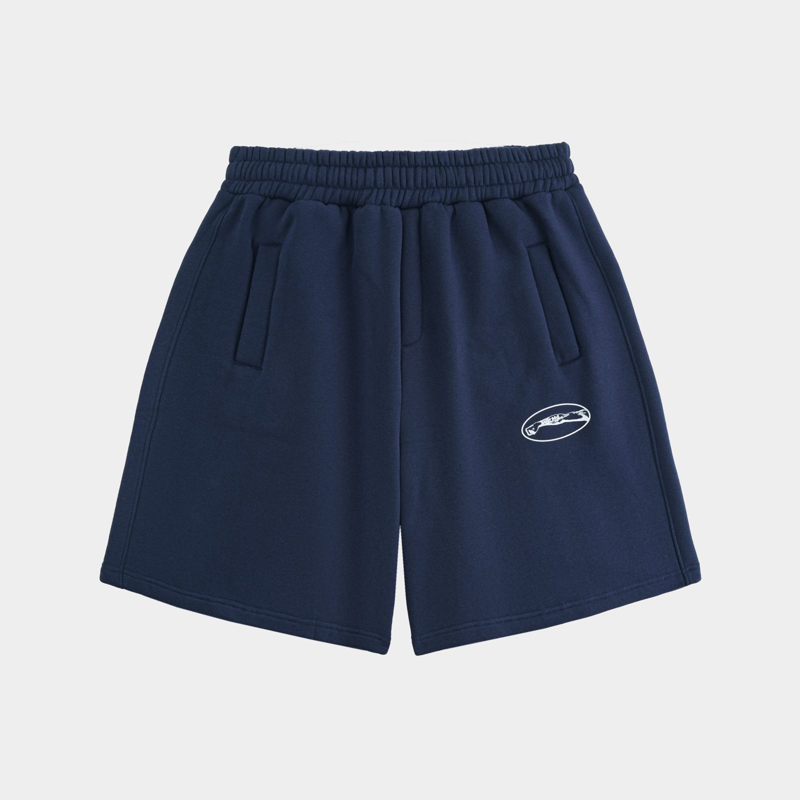 Ảnh 2D trải phẳng quần short nỉ xanh navy in logo, chụp nền xám tại studio Juva Media
